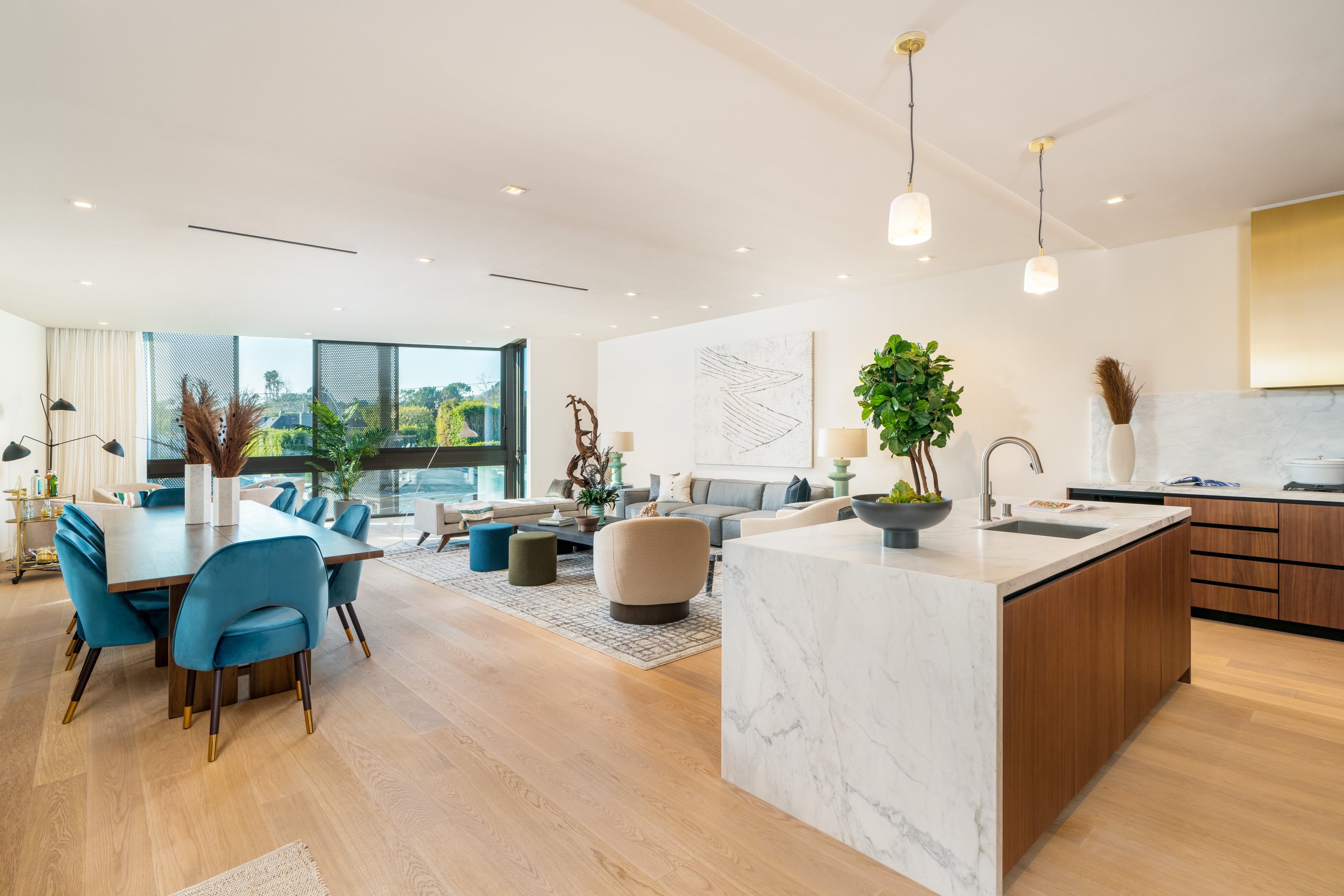 A photo of a sample kitchen with island and sleek cabinetry at The Harland