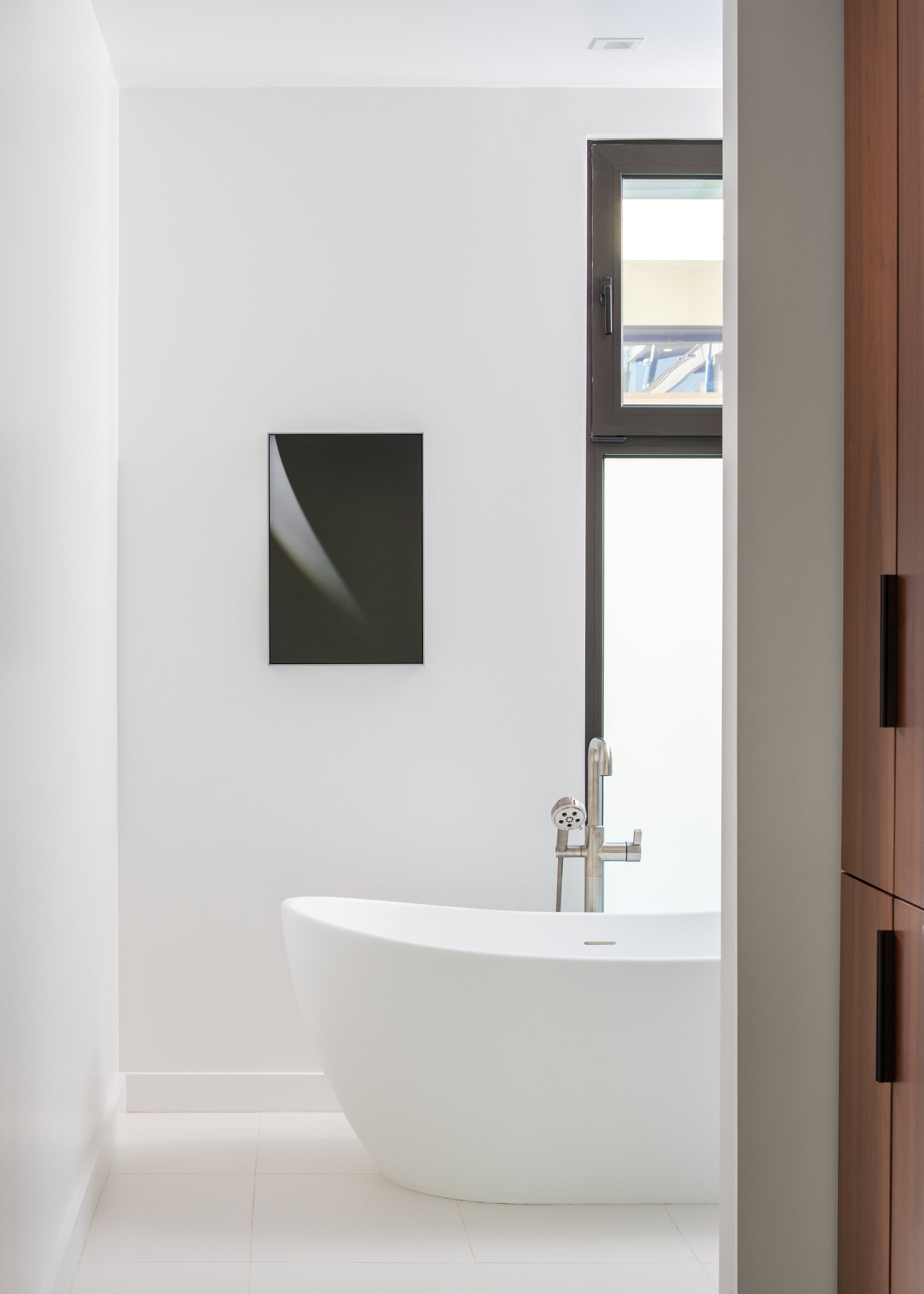 A photo of a sample bathroom with freestanding tub at The Harland
