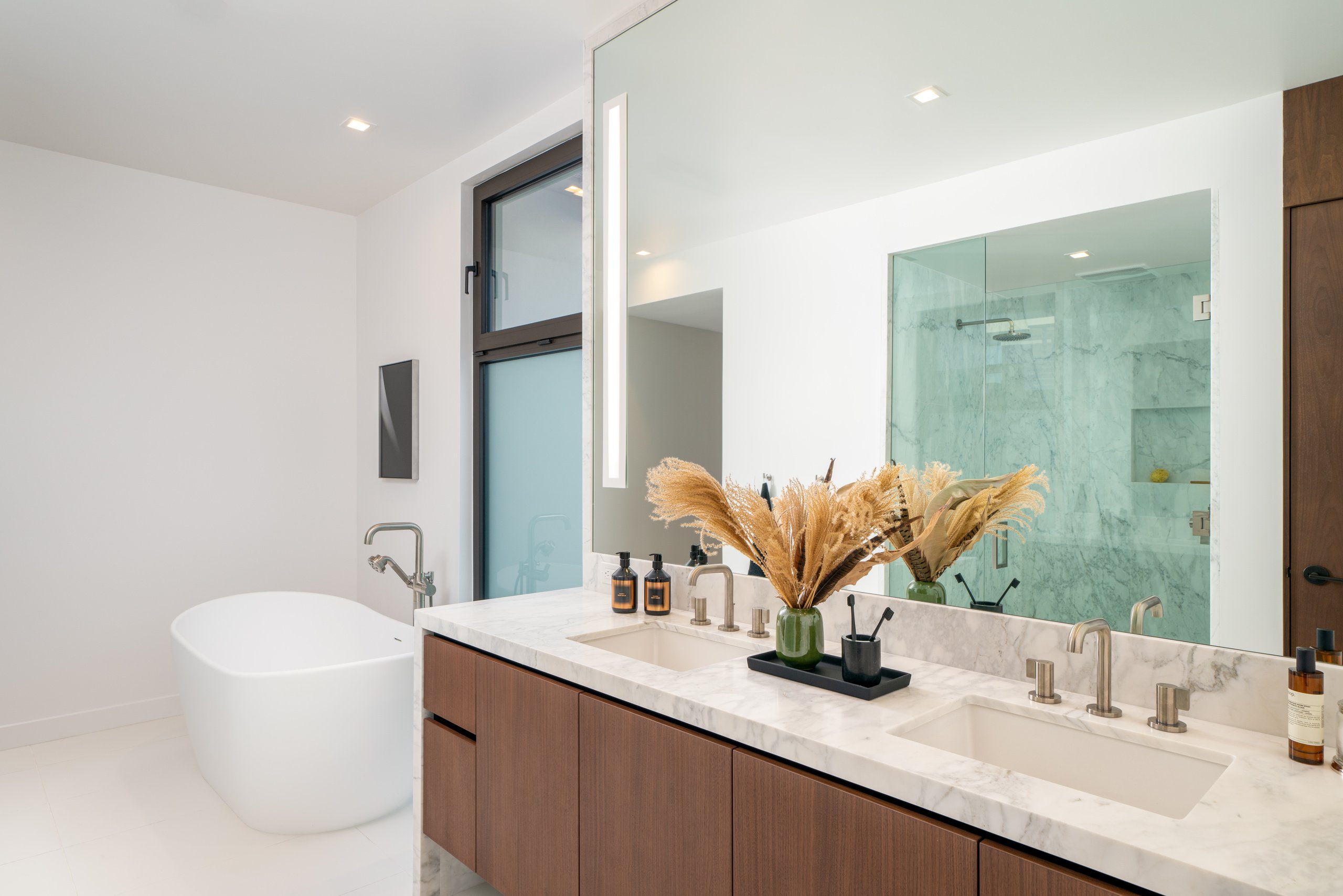 A photo of a sample bathroom with freestanding tub at The Harland